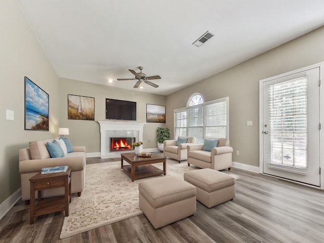 4601 Ethel Springs Trl SW, Mableton, GA 30126 - living area with wood finished floors, a ceiling fan, a fireplace with flush hearth, and plenty of natural light