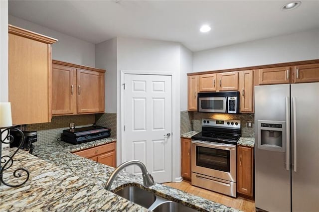 1975 Nocturne Dr Unit 2303, Alpharetta, GA 30009 - kitchen featuring appliances with stainless steel finishes, a sink, light stone counters, tasteful backsplash, and recessed lighting