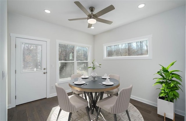 dining room with ceiling fan and dark hardwood / wood-style floors