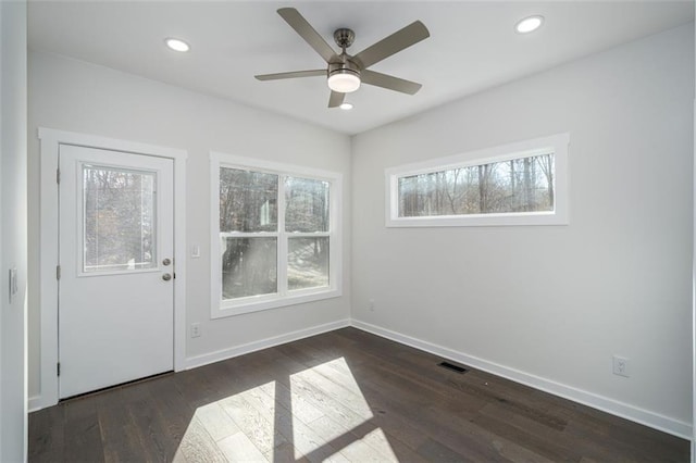 unfurnished room featuring dark hardwood / wood-style flooring and ceiling fan