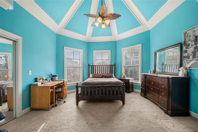 bedroom featuring ceiling fan, carpet floors, high vaulted ceiling, and baseboards