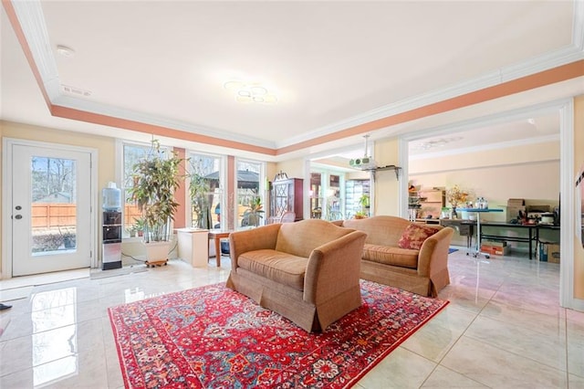 living area featuring light tile patterned floors, plenty of natural light, ornamental molding, and a raised ceiling