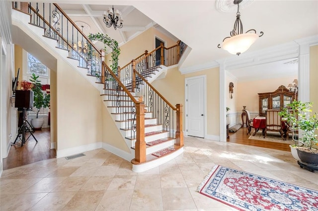 entryway featuring ornamental molding, a high ceiling, coffered ceiling, and baseboards