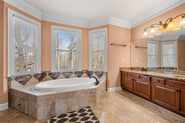 full bath with double vanity, a garden tub, plenty of natural light, and crown molding