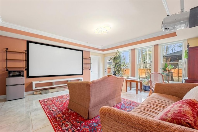 home theater room featuring ornamental molding, baseboards, and light tile patterned floors