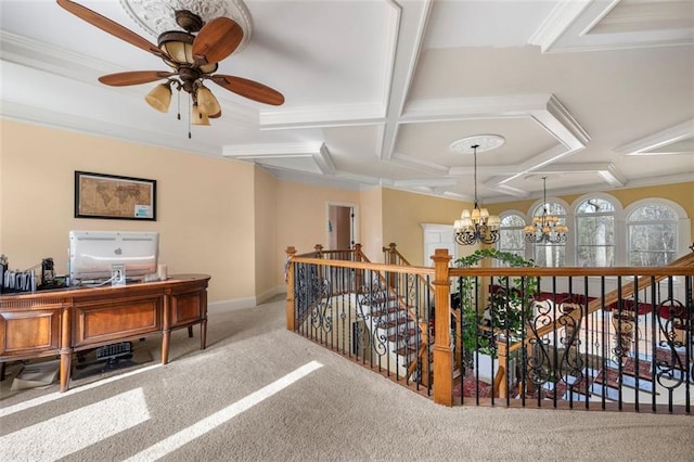 interior space with a chandelier, coffered ceiling, carpet flooring, baseboards, and ornamental molding