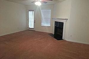 unfurnished living room with carpet flooring and ceiling fan