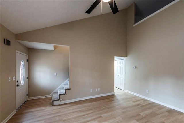 interior space with light wood-type flooring, ceiling fan, and lofted ceiling