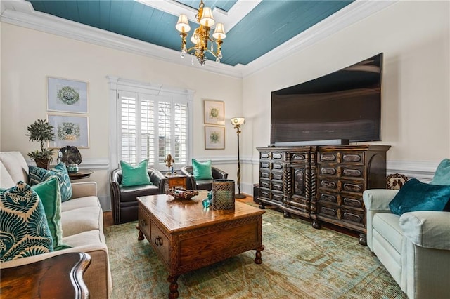 living room featuring a chandelier and ornamental molding