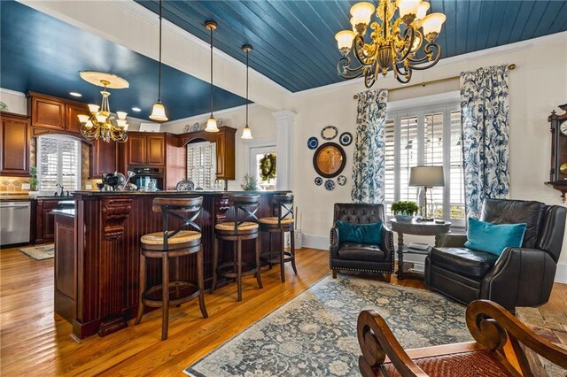 interior space featuring light wood-style flooring, ornamental molding, wood ceiling, and a chandelier