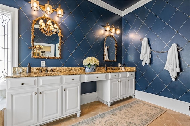 full bathroom featuring an inviting chandelier, double vanity, tile patterned floors, and a sink