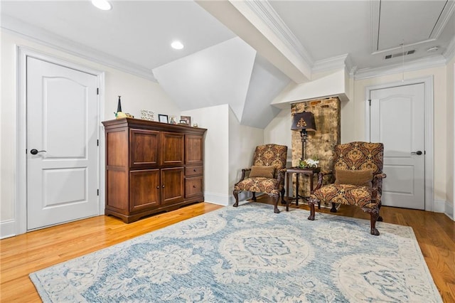 sitting room with light wood finished floors, lofted ceiling, attic access, recessed lighting, and crown molding