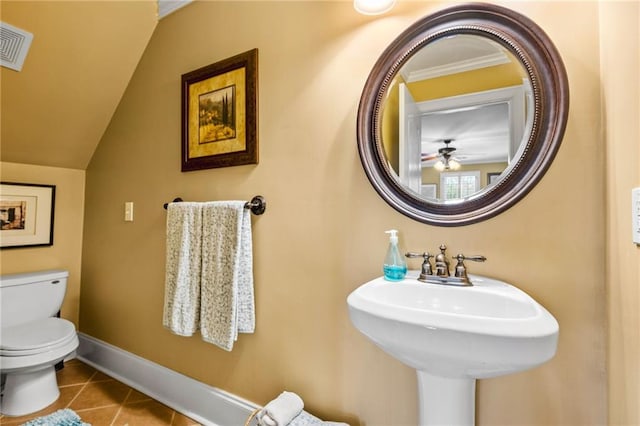 half bath with visible vents, baseboards, toilet, tile patterned floors, and a sink