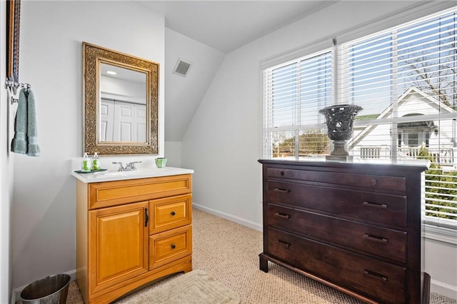 bathroom with vanity, a healthy amount of sunlight, visible vents, and baseboards