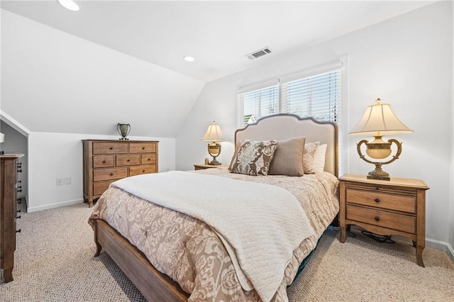 bedroom with vaulted ceiling, carpet flooring, baseboards, and visible vents