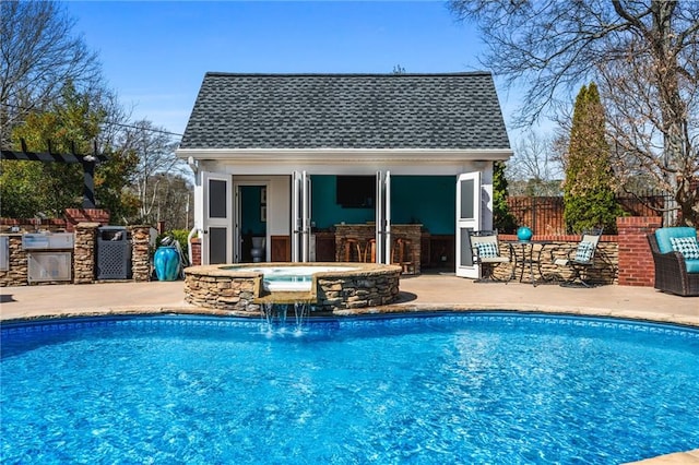 view of swimming pool featuring a fenced in pool, fence, a storage structure, an outdoor structure, and an in ground hot tub