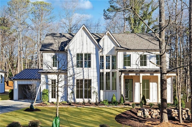 modern inspired farmhouse featuring a garage and a front lawn