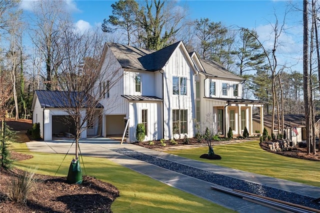 modern inspired farmhouse featuring a front yard and a garage