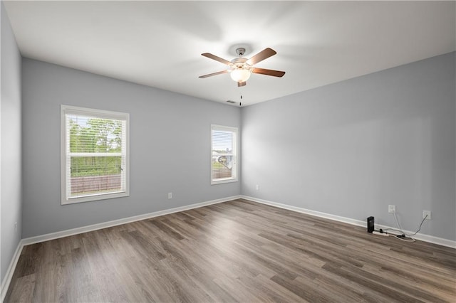 526 Wilbanks Rd, Alto, GA 30510 - unfurnished room with baseboards, a ceiling fan, wood finished floors, and a healthy amount of sunlight
