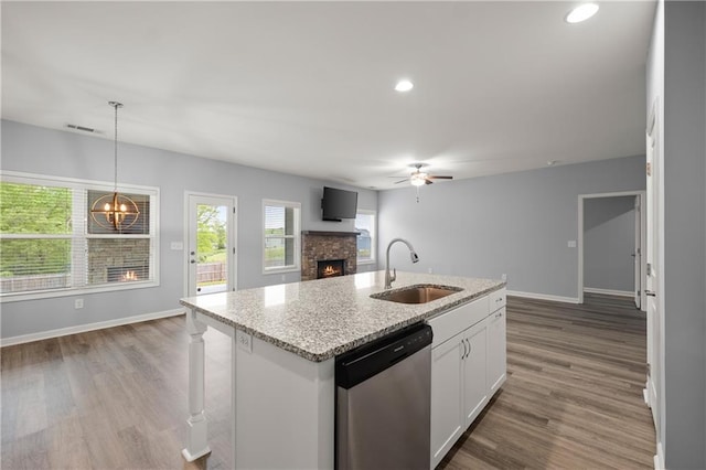 526 Wilbanks Rd, Alto, GA 30510 - kitchen with visible vents, stainless steel dishwasher, a sink, a fireplace, and ceiling fan with notable chandelier