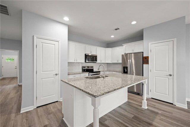 526 Wilbanks Rd, Alto, GA 30510 - kitchen with wood finished floors, visible vents, stainless steel appliances, and a sink