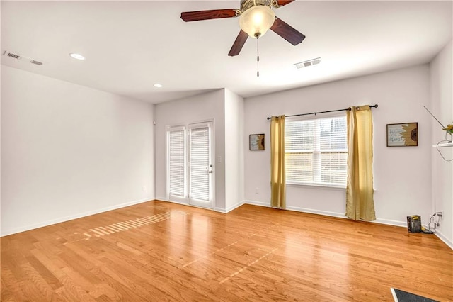 spare room featuring light wood-type flooring and ceiling fan