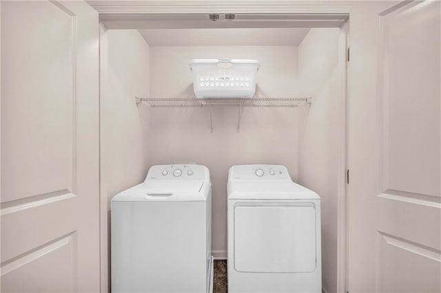 clothes washing area featuring washer and dryer