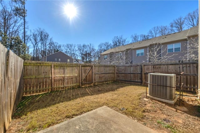 view of yard featuring central AC unit and a patio area