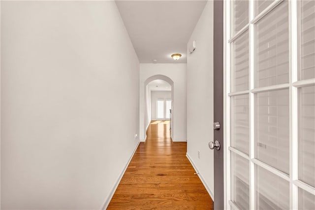 hallway with light hardwood / wood-style floors