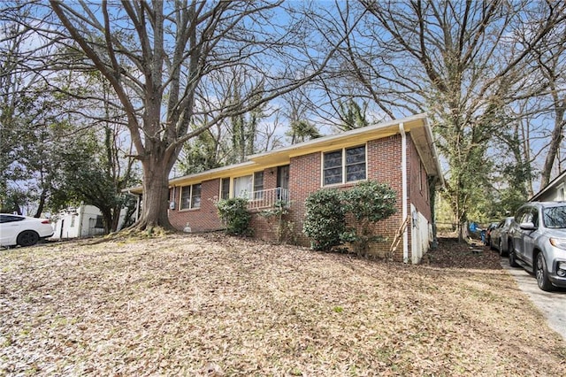 single story home featuring brick siding