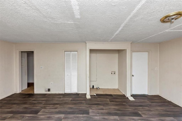 interior space with a textured ceiling and wood finished floors