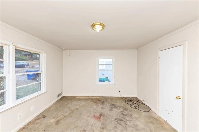 carpeted empty room with visible vents and crown molding