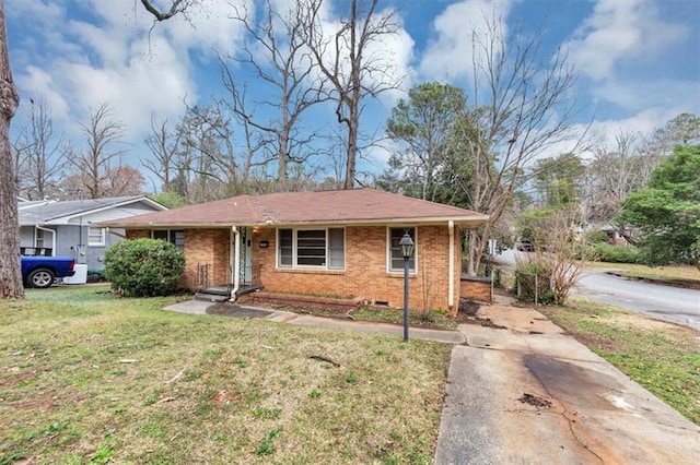 view of front facade featuring a front yard, crawl space, and brick siding