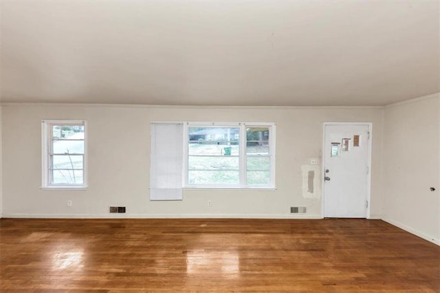 interior space featuring wood finished floors, visible vents, and baseboards