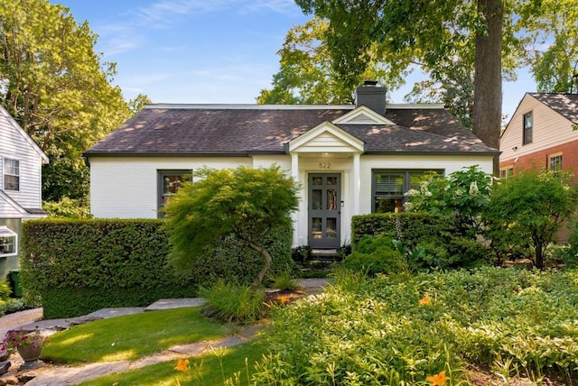 522 Trabert Ave NW, Atlanta, GA 30309 - view of front of house featuring a chimney and roof with shingles