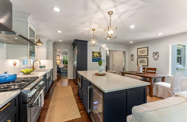 522 Trabert Ave NW, Atlanta, GA 30309 - kitchen featuring stainless steel range, beverage cooler, wall chimney range hood, dark wood finished floors, and recessed lighting