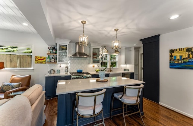 522 Trabert Ave NW, Atlanta, GA 30309 - kitchen featuring wall chimney exhaust hood, light countertops, healthy amount of natural light, tasteful backsplash, and recessed lighting
