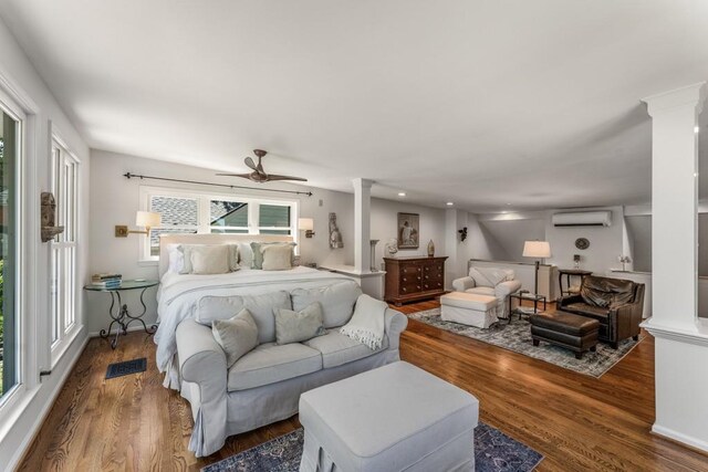 522 Trabert Ave NW, Atlanta, GA 30309 - bedroom with decorative columns, a wall mounted air conditioner, and wood finished floors