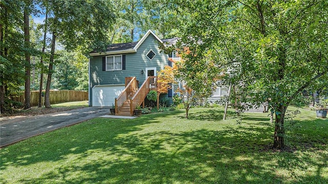 view of front of property with a garage and a front lawn