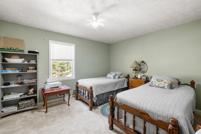 bedroom with baseboards, light colored carpet, ceiling fan, and a textured ceiling