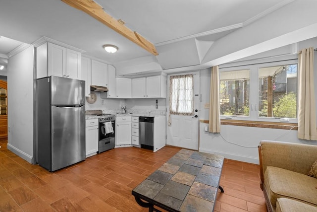 kitchen with white cabinets, appliances with stainless steel finishes, light countertops, and baseboards