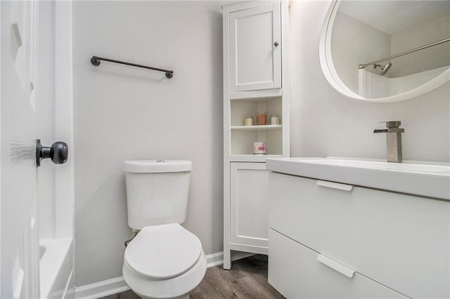 2376 Wellington Cir, Lithonia, GA 30058 - bathroom featuring wood finished floors, vanity, and shower / washtub combination