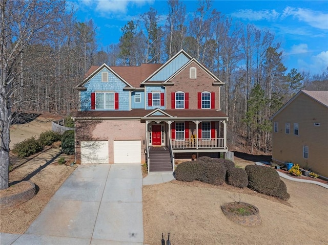 view of front of house with driveway, a porch, and an attached garage