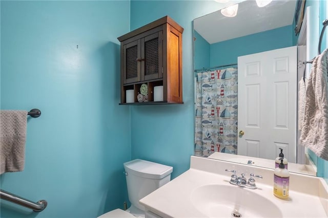 bathroom featuring toilet and vanity