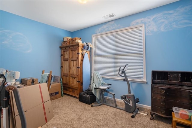 interior space featuring light carpet, visible vents, and baseboards