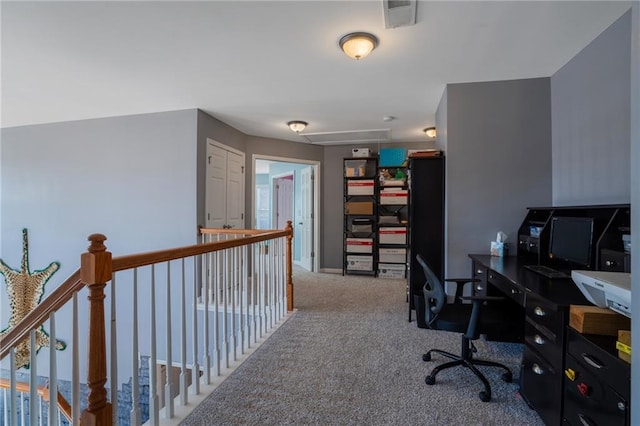 home office with baseboards, carpet flooring, visible vents, and attic access