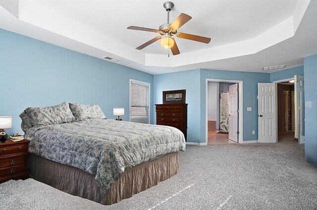 bedroom with visible vents, ceiling fan, and light carpet