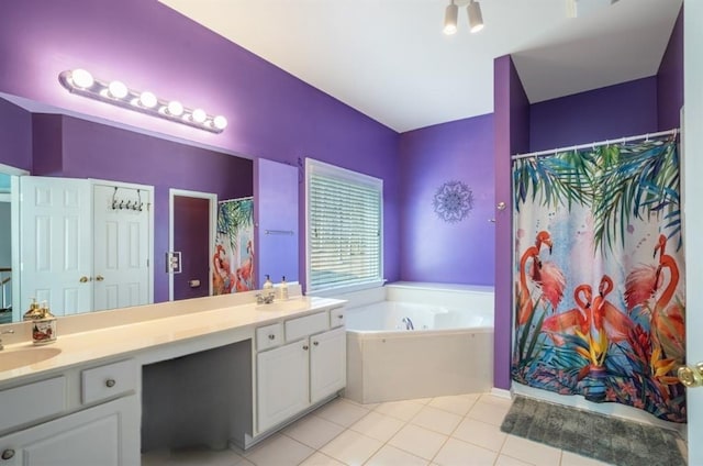 full bath featuring a garden tub, double vanity, a sink, and tile patterned floors