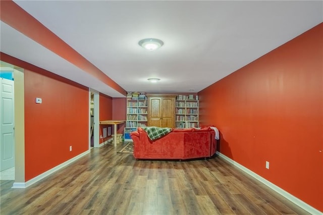 living room with baseboards and wood finished floors