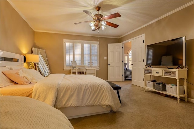 bedroom with carpet, ceiling fan, and crown molding